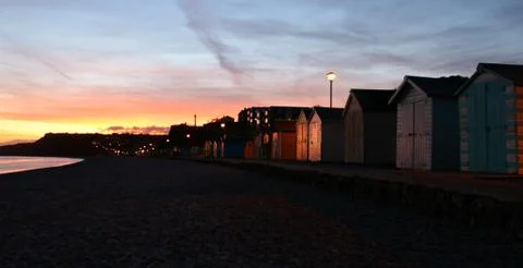 Budliegh beach huts at sunset Stock Photos
