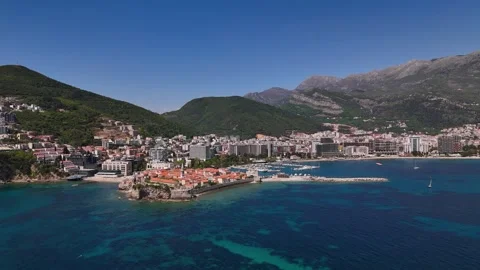 Budva Old Town aerial view with Adriatic coastline, marina, and mountains Stock Footage 339034957