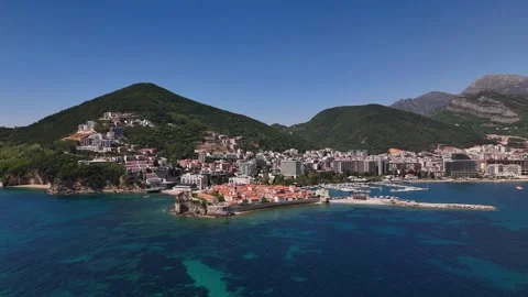 Budva Old Town peninsula with marina and turquoise Adriatic waters from drone Stock Footage 337076994