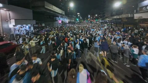 Buenos Aires, Argentina - 2026/07/15: empty street leads to dense crowd Stock Footage 341773556