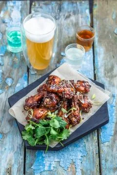 Buffalo chicken wings with beer, rustic background, copy space Stock Photos