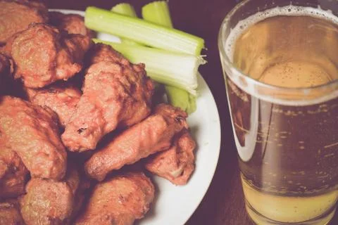 Buffalo Wings with Celery Sticks and Beer Stock Photos