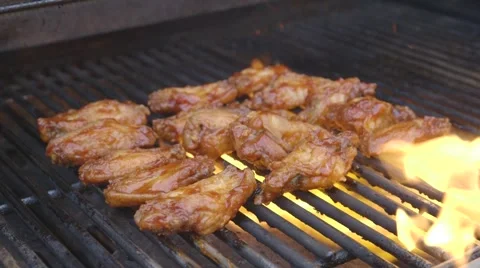 Buffalo wings flaming on a grill Stock Footage