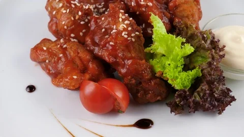 Buffalo wings with vegetables and hot sauce, close-up view Stock Footage 80142972
