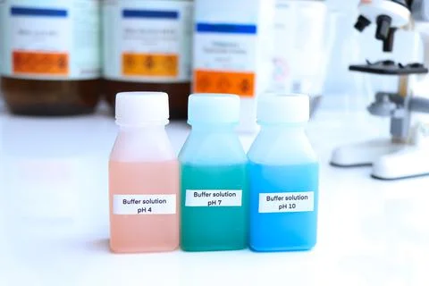 Buffer solution in glass, chemical in the laboratory and industry Stock Photos