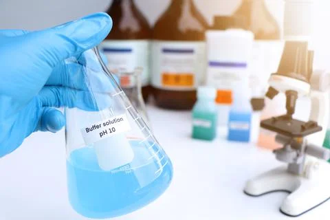 Buffer solution in glass, chemical in the laboratory and industry Stock Photos