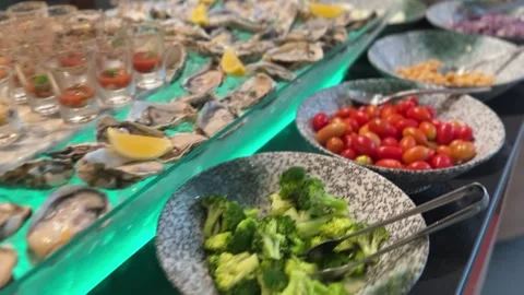 Buffet with bell peppers, broccoli, tomatoes, and oysters Stock Footage 314708345