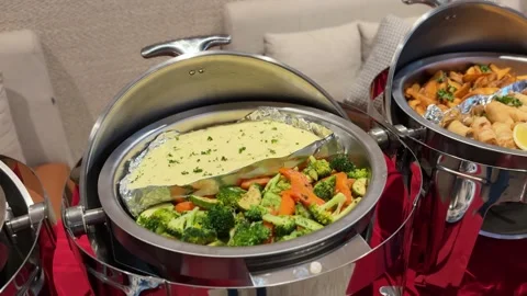 Buffet chafing dishes with baked fish vegetables and fried appetizers Stock Footage 331110570