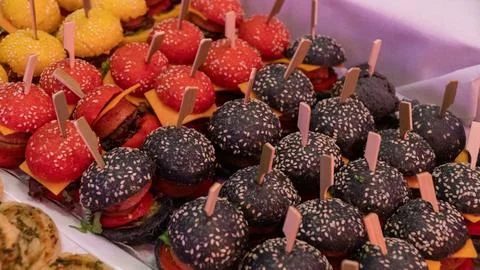 Buffet colored burgers are on the table Фото