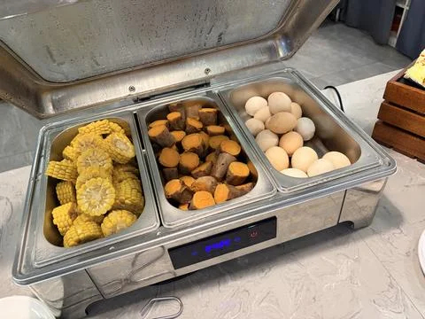 Buffet with corn, sweet potatoes, and eggs. Stock-Fotos
