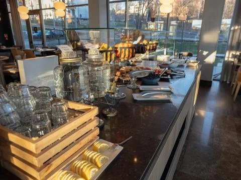 A buffet counter with fresh fruit, lemon slices, and water dispensers at a Stock Photos
