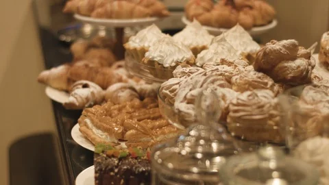 The buffet is covered with different tasty desserts covered with castor sugar Stock Footage 88672114