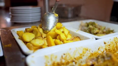 Buffet food service involves people serving themselves from a selfservice line Stock Footage 276420474