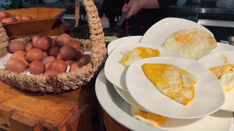Buffet fried eggs on white plates Delicious breakfast with fried eggs. Top view Stock Footage 316233932