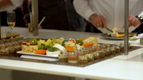 Buffet guests put food on a plate 스톡 동영상 235581411