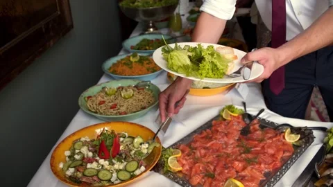 Buffet, guests put food on their plates Stock Footage 247684502