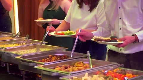 Buffet guests putting food on plates 스톡 동영상 277436752