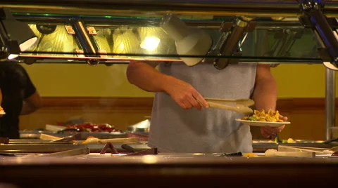 Buffet Guy fills plate Stock Footage 41261903