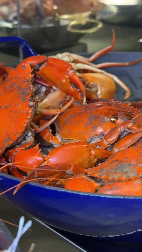 Buffet large selection of dishes asia seafood shrimp being poured from a hot pan Stock Footage 313737818