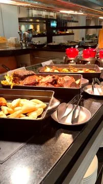 Buffet offering roasted vegetables in cast iron plates ,rich gravies ,perfectly Stock Photos