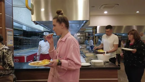 Buffet restaurant guests put food on plates. Stock Footage 202246997