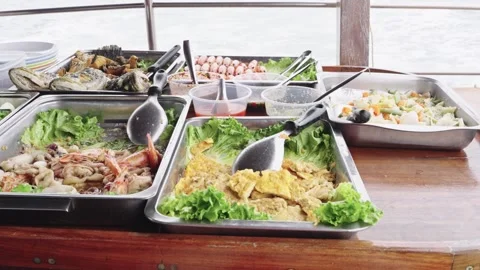 Buffet seafood spread on a wooden table aboard a boat with sea view. Includ.. Stock Footage 342250513