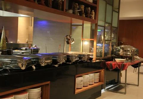 A buffet station in an upscale restaurant, featuring stainless steel chafing Stock Photos