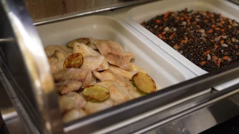Buffet Style Restaurant Food Selection with Fish in Serving Trays Stock Footage 346397805