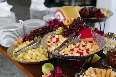Buffet Table with Assorted Cheese Board Fruits and Metallic Stands for Hote.. Stock Photos