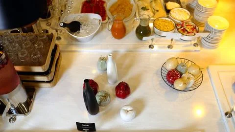 Buffet table with assorted drinks snacks and decorative ceramic fruits on m.. Stock-Fotos