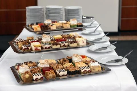 Buffet Table with Assorted Mini Cakes. Elegant dessert buffet setup with Stock Photos