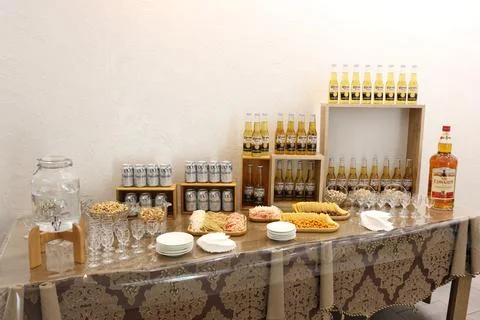 Buffet table with beer, cheese, chips and nuts. Stock Photos