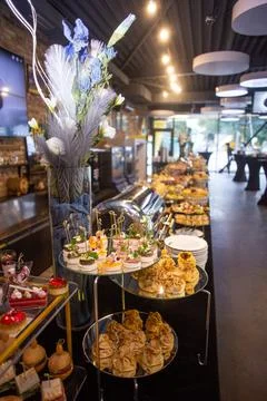 Buffet table with a black tablecloth with various snacks and treats catering Stock Photos