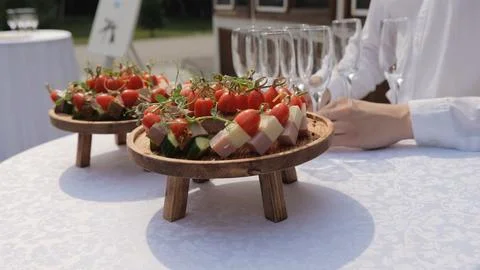 Buffet table, canape with cheese, cherry tomato and olive. Champagne with Stock Photos