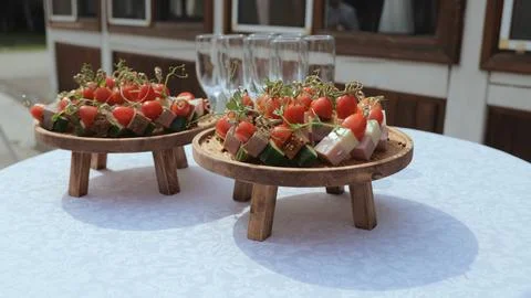 Buffet table, canape with cheese, cherry tomato and olive. Champagne with Stock Photos