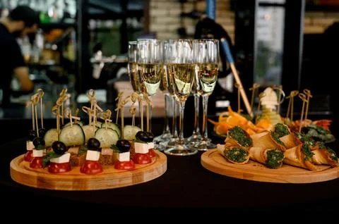 Buffet table with canapes and champagne in tall glasses in a restaurant Stock Photos