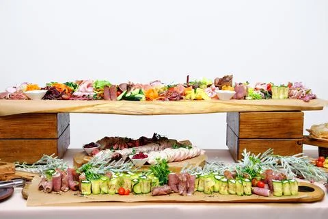 Buffet table with cold appetizers. Meat and vegetable snacks are placed on Photos