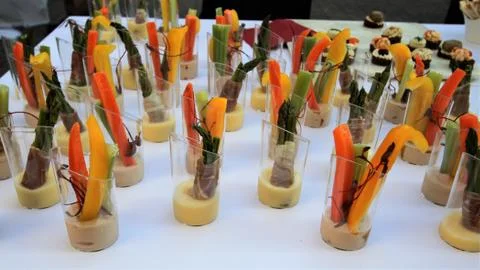 Buffet table with  cut vegetable hors d'oeuvres on a white tablecloth Stock Photos