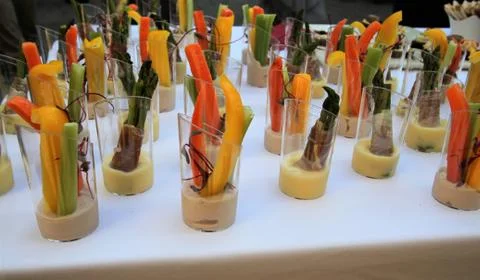 Buffet table with  cut vegetable hors d'oeuvres on a white tablecloth Stock Photos