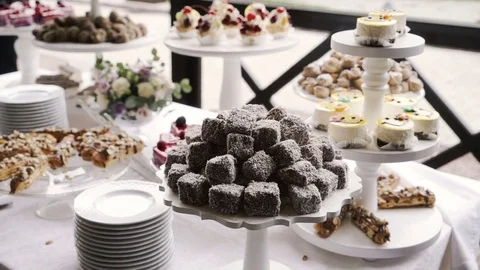 A buffet table with desserts. Cake, tartlets, eclairs Stock Footage 83001347