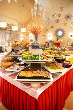 Buffet table with different dishes in a beautiful restaurant Stock Photos