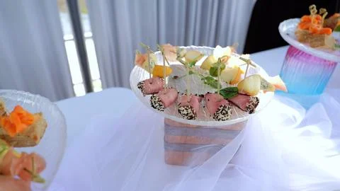 Buffet table displaying diverse catering appetizers, featuring bite sized Stock Photos