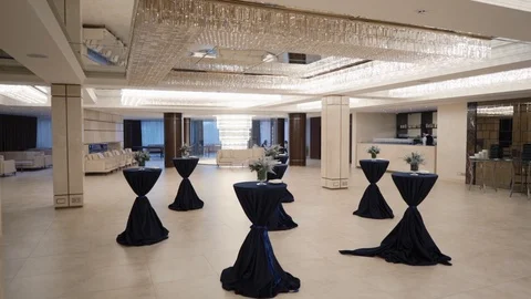 Buffet table with flowers in a large restaurant hall Stock Footage 127669110