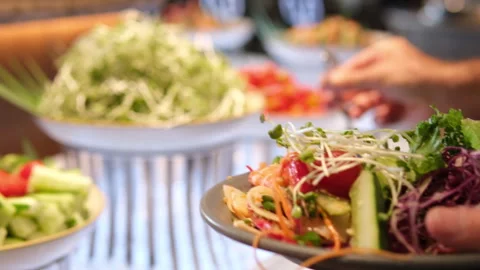 Buffet table with Fresh and Vibrant Organic Vegetables in Rustic Clay Bowls and Video stock 317700752