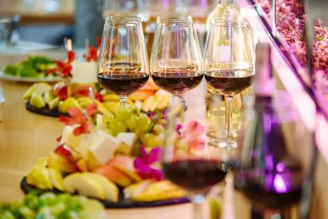 Buffet table with fruit and glasses with red wine Stock Photos