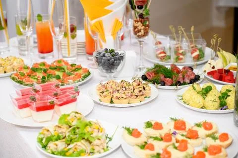 Buffet table with fruit and meat snacks and canapés Stock Photos
