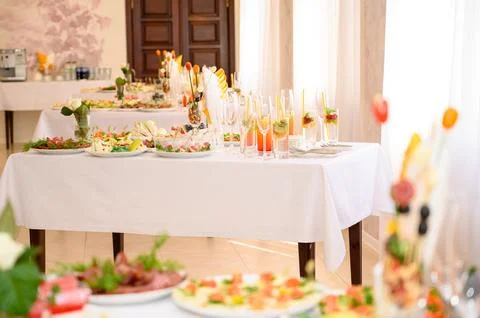 Buffet table with fruit and meat snacks and canapés Stock Photos
