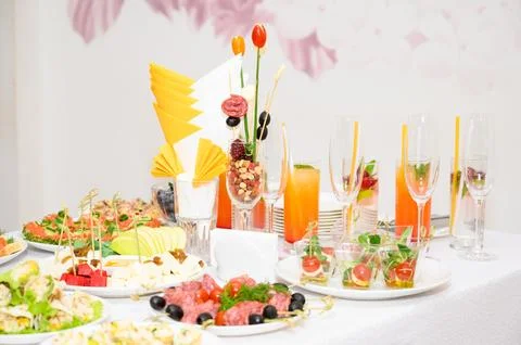 Buffet table with fruit and meat snacks and canapés Stock Photos
