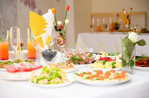 Buffet table with fruit and meat snacks and canapés Stock Photos