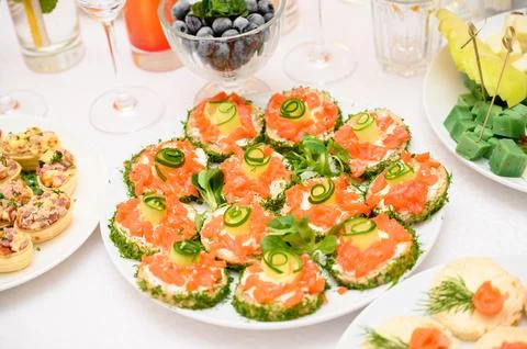 Buffet table with fruit and meat snacks and canapés Stock Photos